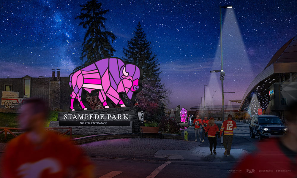 Nighttime rendering of Stampede Park's north entrance in Calgary, featuring a large, illuminated geometric bison statue above the entrance sign. Blurred figures and a vehicle are visible under streetlights, set against a starry sky.