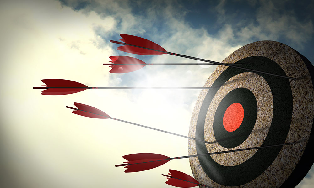arrows missing bullseye on a target with sky and clouds in the background