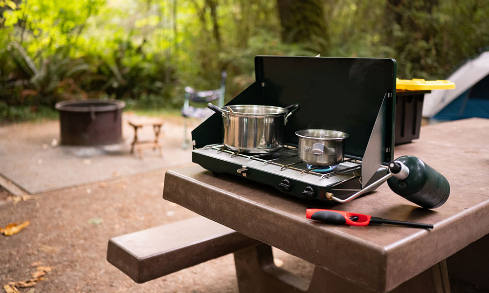 camping stove on a picnic table