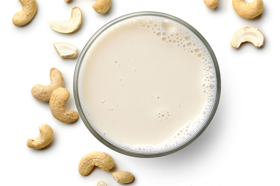 almond milk surrounded by loose almonds