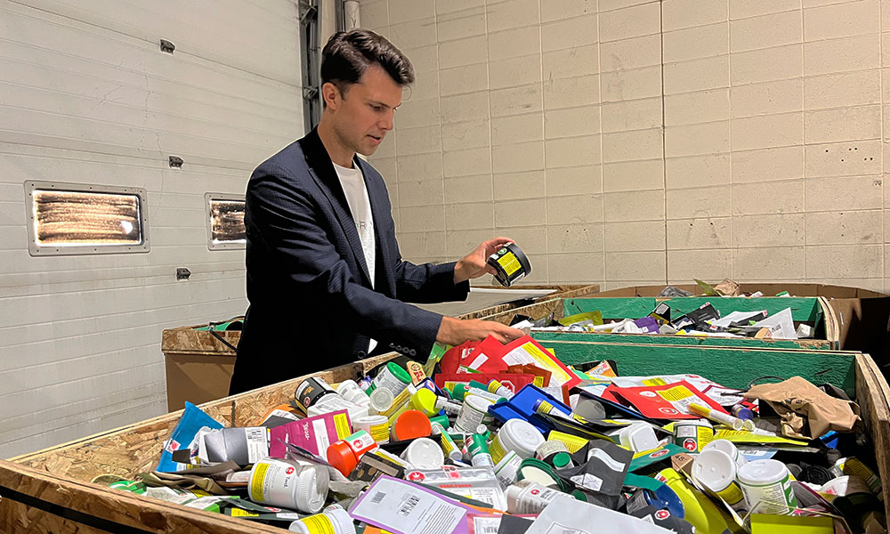corey saban, nait grad and founder of Re Waste recycling and manufacturing facility sorts through plastic to be recycled