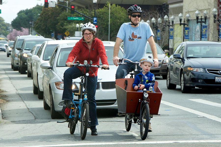 family cycling in a city
