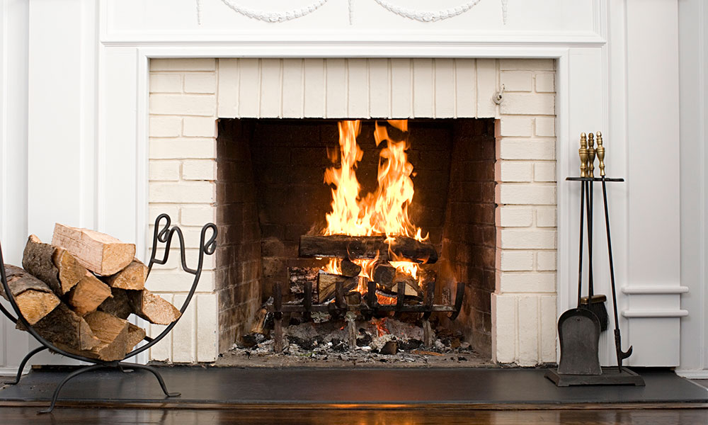 fire burning in a fireplace with a white mantle