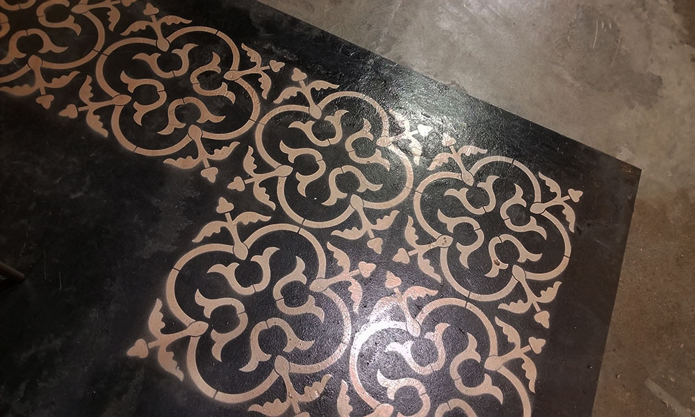 floor pattern painted onto concrete under table in lobby at first edmonton general restoration