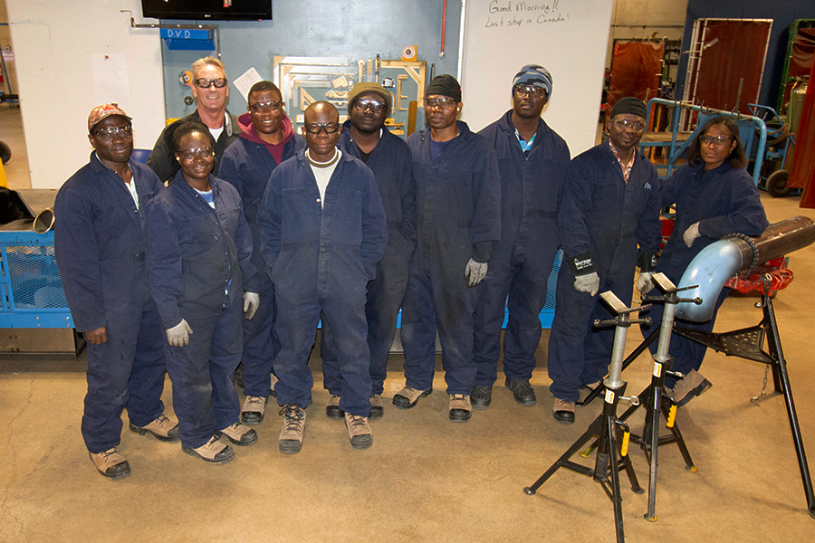 ghanaian students at NAIT lwith instructor Jim Cameronearning pipefitting