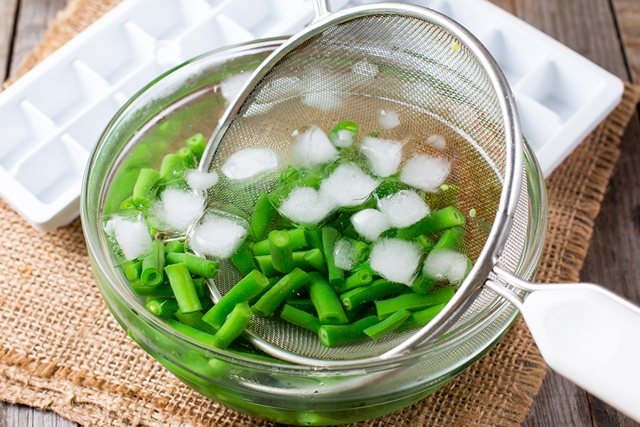 blanched green beans in ice-water bath