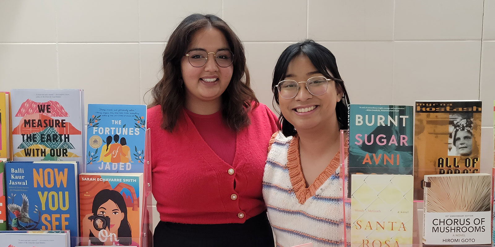 Photo of Kareena Virdi and Rajah Maggay, owners of in her words bookshop, with their books at a pop-up market