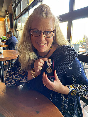 jodi manz-henezi, nait chair of the disaster and emergency management program, showing of her queen elizabeth II's platinum jubilee medal