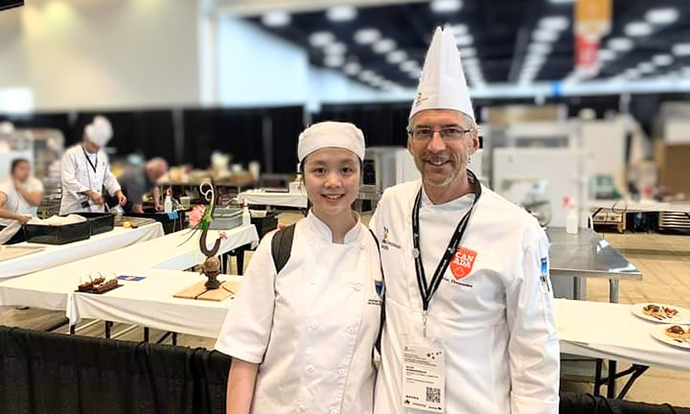 nait baking and pastry arts student judy lan with program chair alan dumonceaux at skillscanada competition