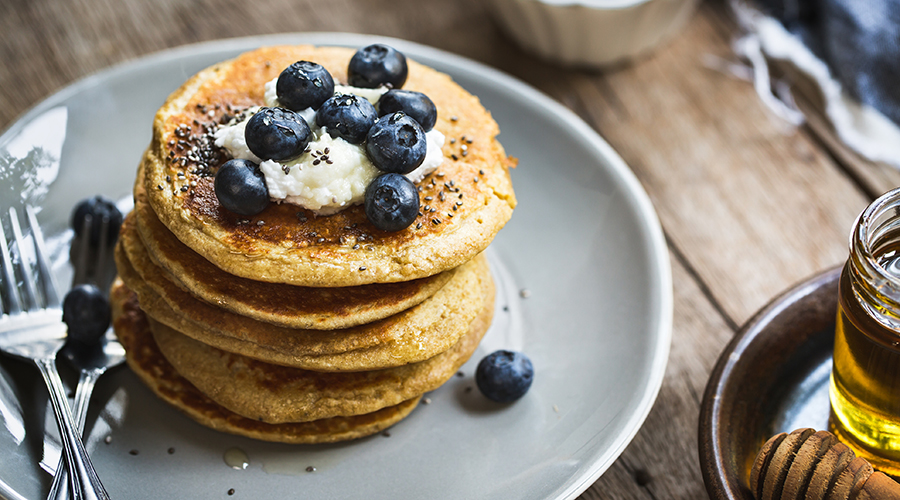 stack of pancakes with blueberries and chia seeds on top