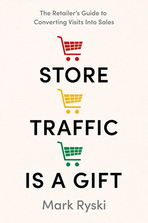 Book cover of 'Store Traffic is a Gift' by Mark Ryski, featuring the subtitle 'The Retailer's Guide to Converting Visits Into Sales' and three shopping cart icons in red, yellow, and green between the title words.