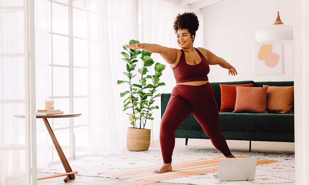woman doing yoga in her living room