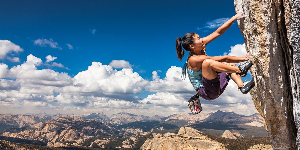 woman rock climbing in the mountains