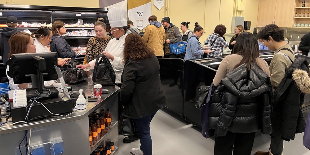 customers crowd NAIT's Artisanal food market