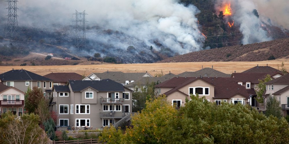 wildfire burning behind neighbourhood