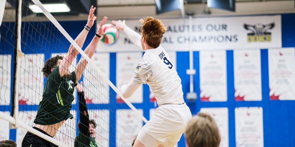 nait men's ooks volleyball player jumps at the net